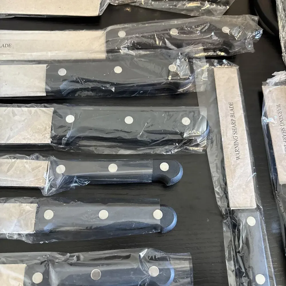 14 Piece serrated stainless steel blades and black handles with triple rivets